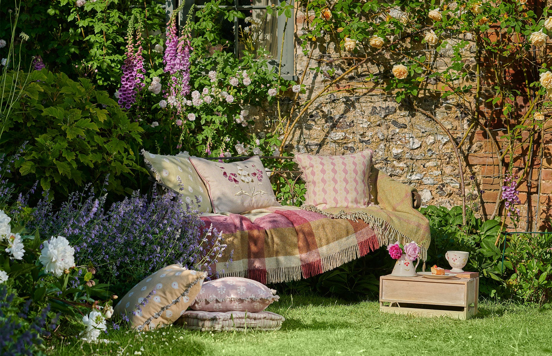 Outdoor cushions on a picnic blanket in the summer by Susie Watson Designs
