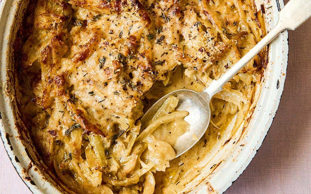 Fennel in a rustic gratin dish cooked with onions, creme fraiche and nutmeg